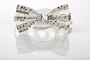 White bow tie with notes on a white background