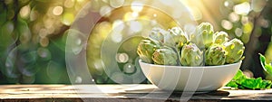 white bowl of artichokes on nature background