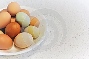 White bowl with colorful eggs