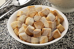 White bowl with croutons for seasoning close up