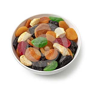 White bowl with dried fruit, tutti frutti, on white background close up photo