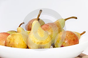 White bowl filled with fresh pears