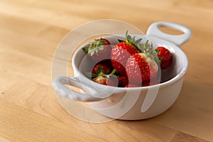 white bowl filled with fresh strawberries