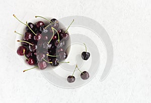 White Bowl with Fresh Cherries on White Marble