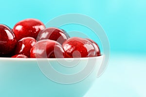 White Bowl Of Fresh Red Cherries On Turquoise