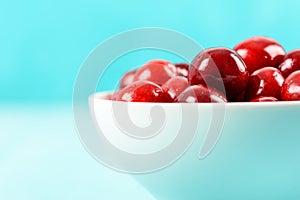 White Bowl Of Fresh Red Cherries On Turquoise