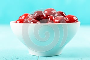 White Bowl Of Fresh Red Cherries On Turquoise