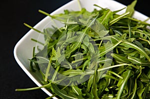 White bowl of fresh rocket salad