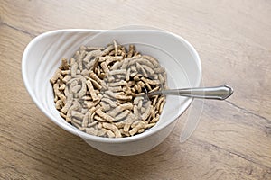 White bowl of healty cereals on wooden background