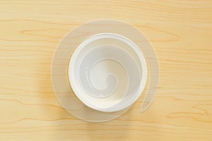 White bowl isolated on wooden background