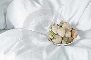 white bowl with some white strawberries