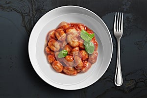White bowl with tomato potato gnocchi
