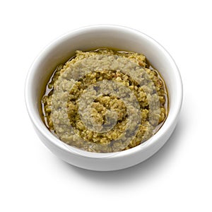 White bowl with traditional homemade green olive tapenade close up on white background photo