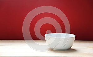 White bowl on wooden table red empty space background.Food backdrop