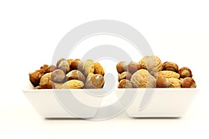 White bowls with assorted nuts