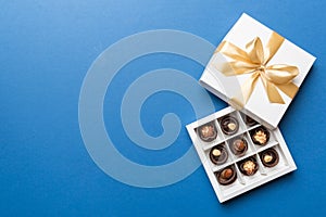 White box with chocolates candies and golden tape. top view with copy space