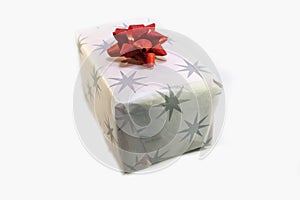 White box, christmas present with stars decorate wrap and red shiny ribbon in white isolated container. Decoration paper for xmas