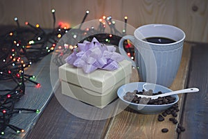 White gift box, blue cup, coffee beans in blue pialn