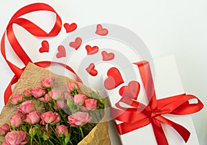 White box, red hearts and red ribbon. Bouguet pink rose