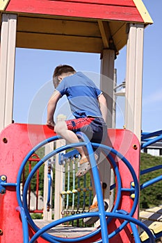 White boy climbing on playground