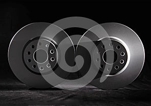 White brake discs on a black background. Efficient braking, safety. Close-up
