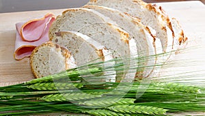 White Bread with crop barley on wooden background