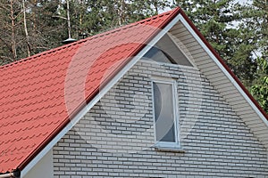 White brick attic with windows of a private house