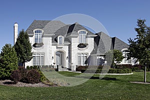 White brick home with arched entry