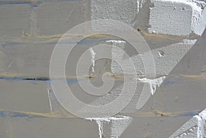 White brick masonry painted white with shadow and sun