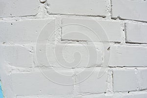 White brick masonry painted white with shadow and sun
