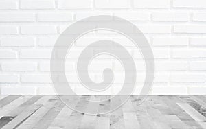 White brick wall background with perspective light wood, slightly blurry wood foreground