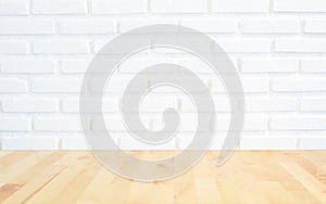 White brick wall background with perspective light wood, slightly blurry wood foreground