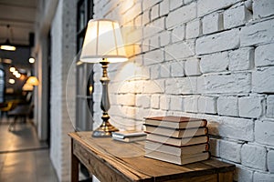 White brick wall, books and lamp