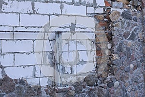 White brick wall and gray stone foundation