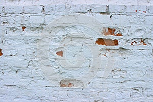 White brick wall, grunge texture background. The texture of the old brick wall is painted white with paint.