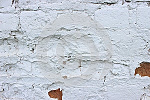 White brick wall, grunge texture background. The texture of the old brick wall is painted white with paint.