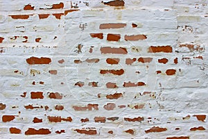 White brick wall, grunge texture background. The texture of the old brick wall is painted white with paint.