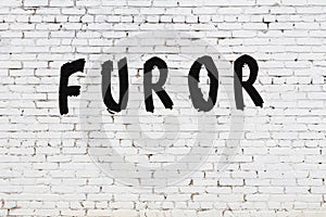 Word furor painted on white brick wall