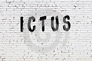 Word ictus painted on white brick wall photo