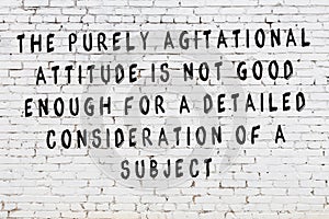 White brick wall with painted black inscription of wise quote