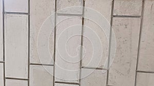 A white brick wall with a pattern of squares