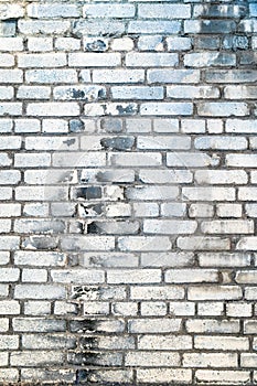 White brick wall texture background. Wall with blue, grey and black paint