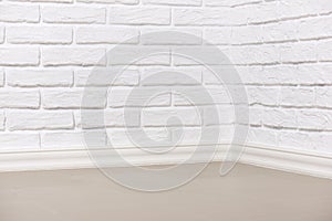 White brick wall with tiled floor, abstract background photo