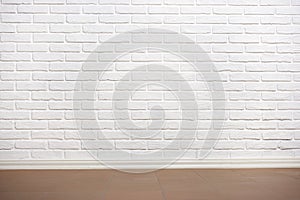 White brick wall with tiled floor, abstract background photo