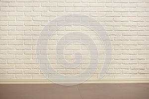 White brick wall with tiled floor, abstract background photo, yellow toned