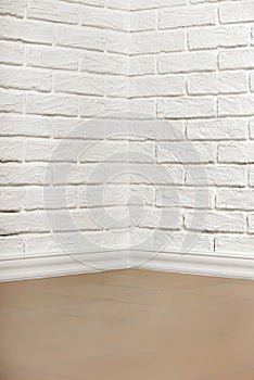 White brick wall with tiled floor and corner, abstract background photo