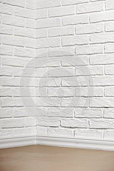 White brick wall with tiled floor and corner, abstract background photo