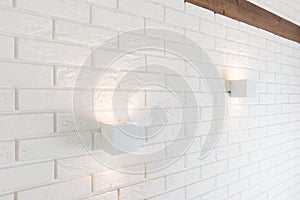 White brick wall with two lights