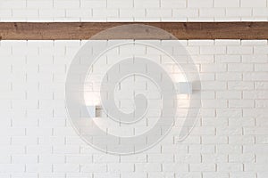 White brick wall with two lights