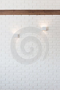 White brick wall with two lights